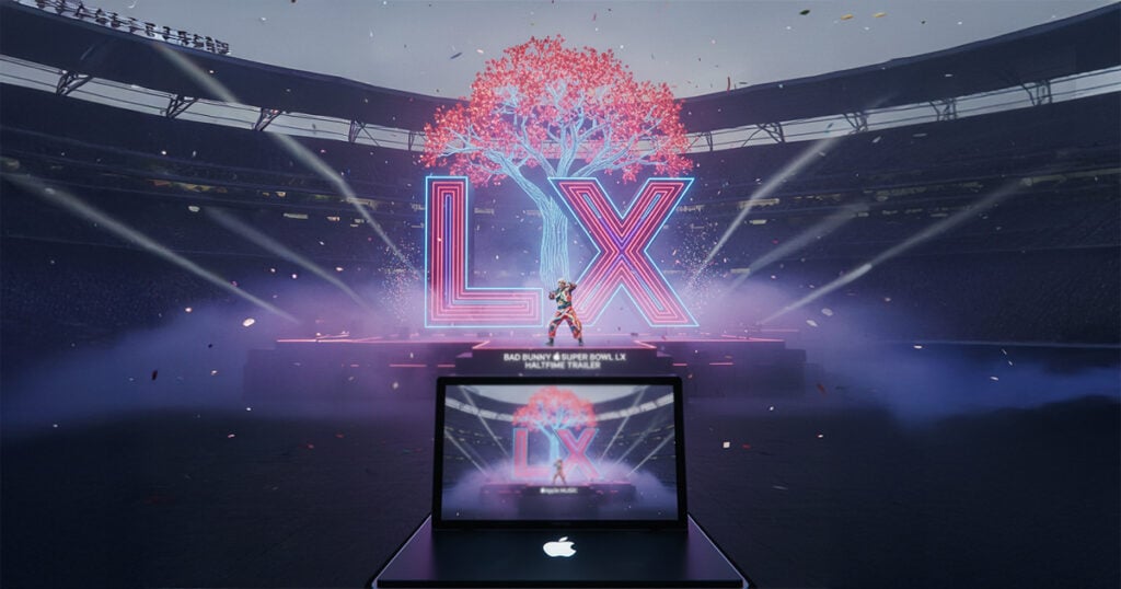 Super Bowl LX stadium stage with large illuminated LX letters, a digital tree centerpiece, and a performance scene displayed on a MacBook in the foreground.