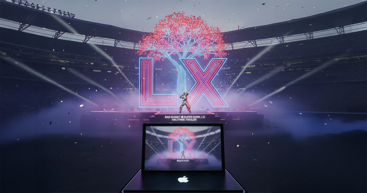 Super Bowl LX stadium stage with large illuminated LX letters, a digital tree centerpiece, and a performance scene displayed on a MacBook in the foreground.