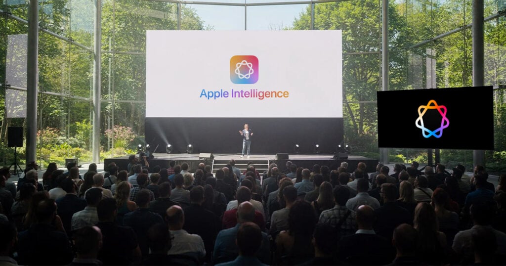 Presenter on stage at Apple event unveiling Apple Intelligence on large screen in a glass venue surrounded by trees with audience watching.
