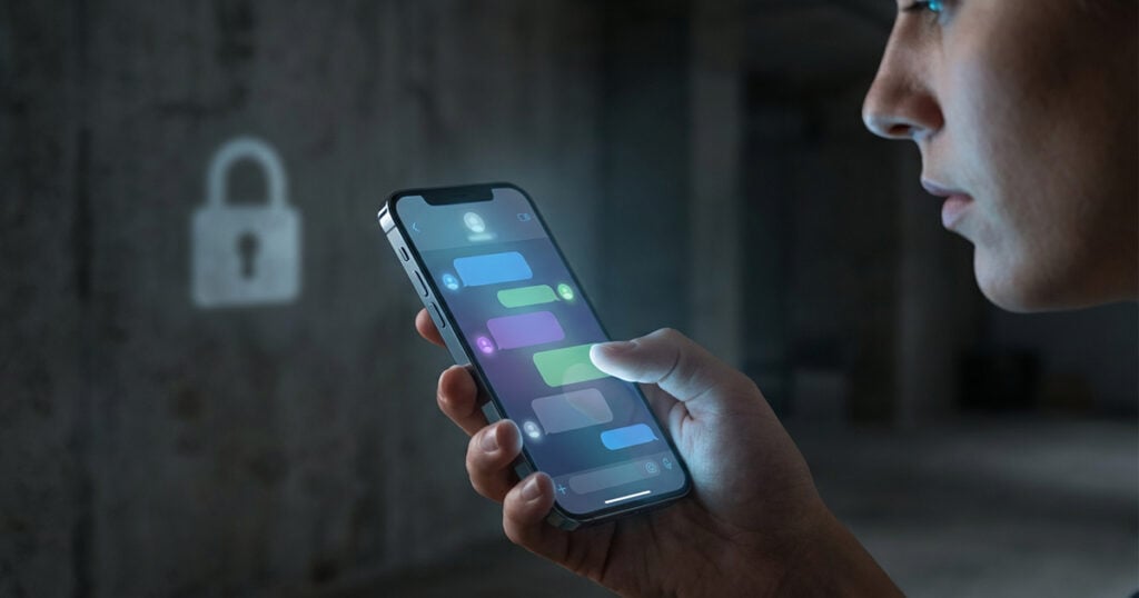 Person holding iPhone displaying secure messaging app with lock icon symbolizing end to end encrypted RCS messaging.