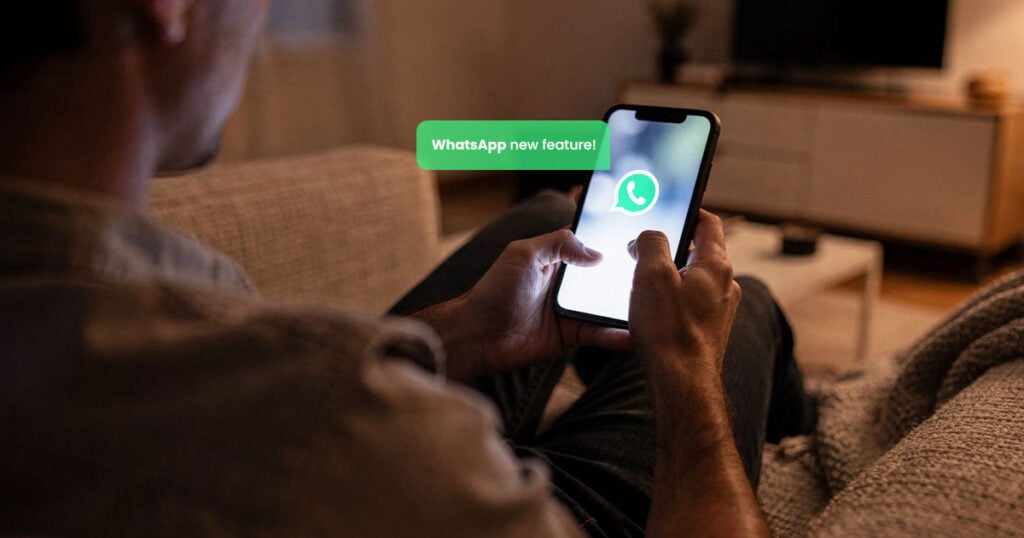 Person using WhatsApp on smartphone with new feature notification displayed on screen