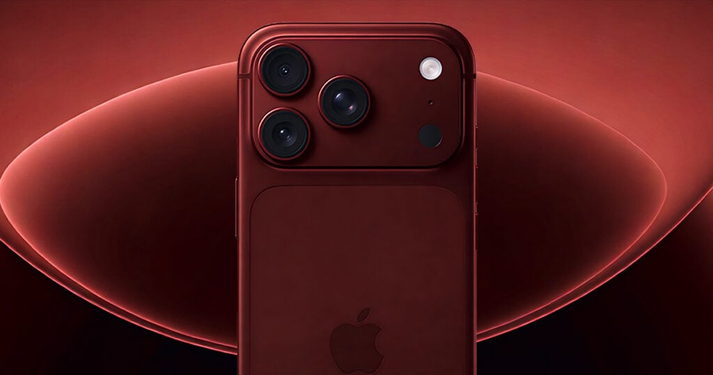 Deep red iPhone Pro model with triple camera system and Apple logo against a matching red background
