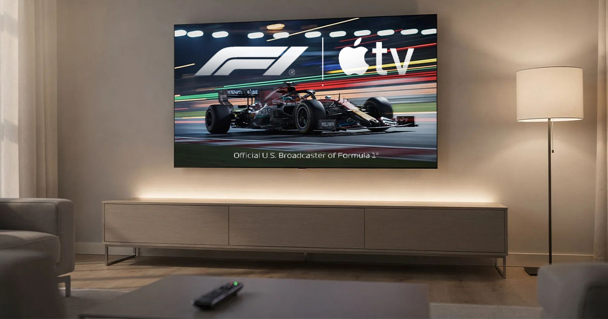 A wall-mounted TV in a warmly lit living room displays an F1 car in motion with the Formula 1 and Apple TV logos above the text "Official U.S. Broadcaster of Formula 1."