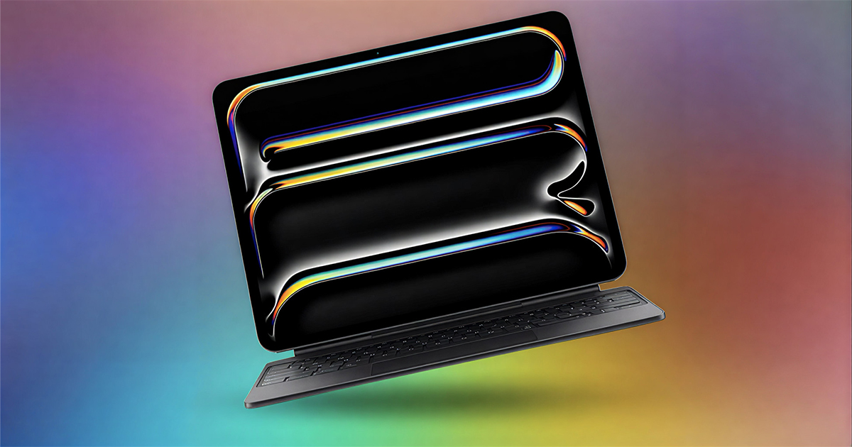 A black iPad Pro attached to a Magic Keyboard floats at an angle, its screen showing a glossy black wallpaper with iridescent chrome ribbons, against a soft rainbow gradient background.